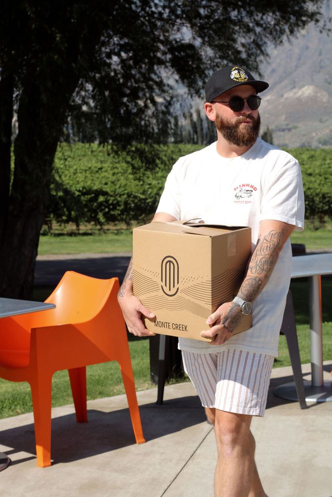 Man carrying a case of wine out of the Tasting Room